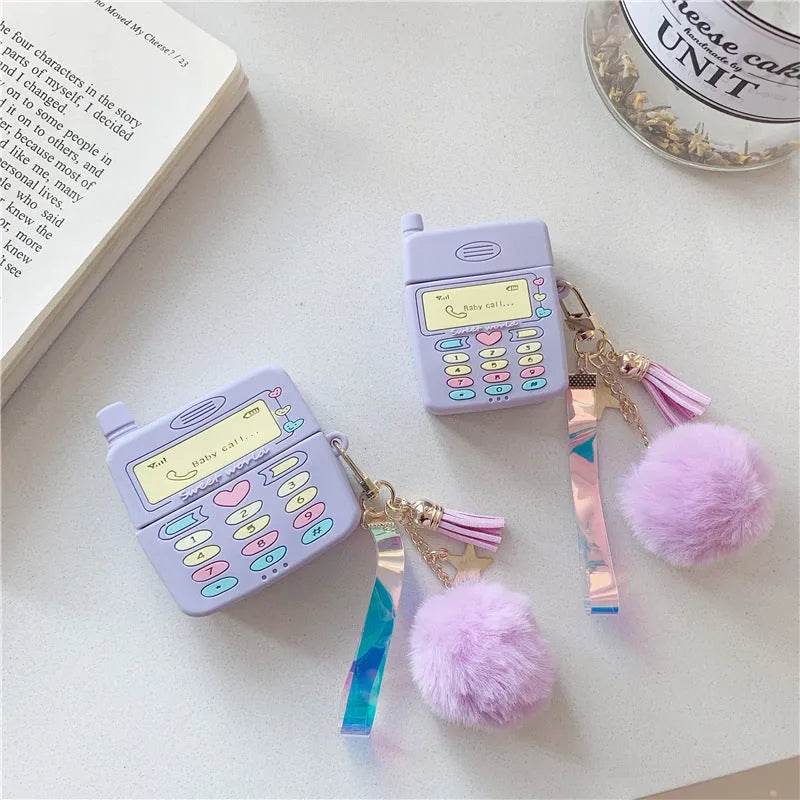 Purple silicone AirPods case with fur ball pendant for wireless Bluetooth headphones