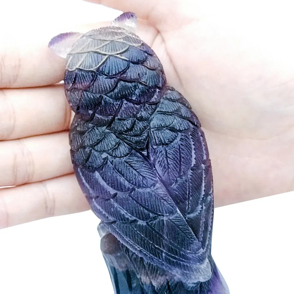Hand carved purple fluorite owl ornament showing natural stone texture and 4 inch size