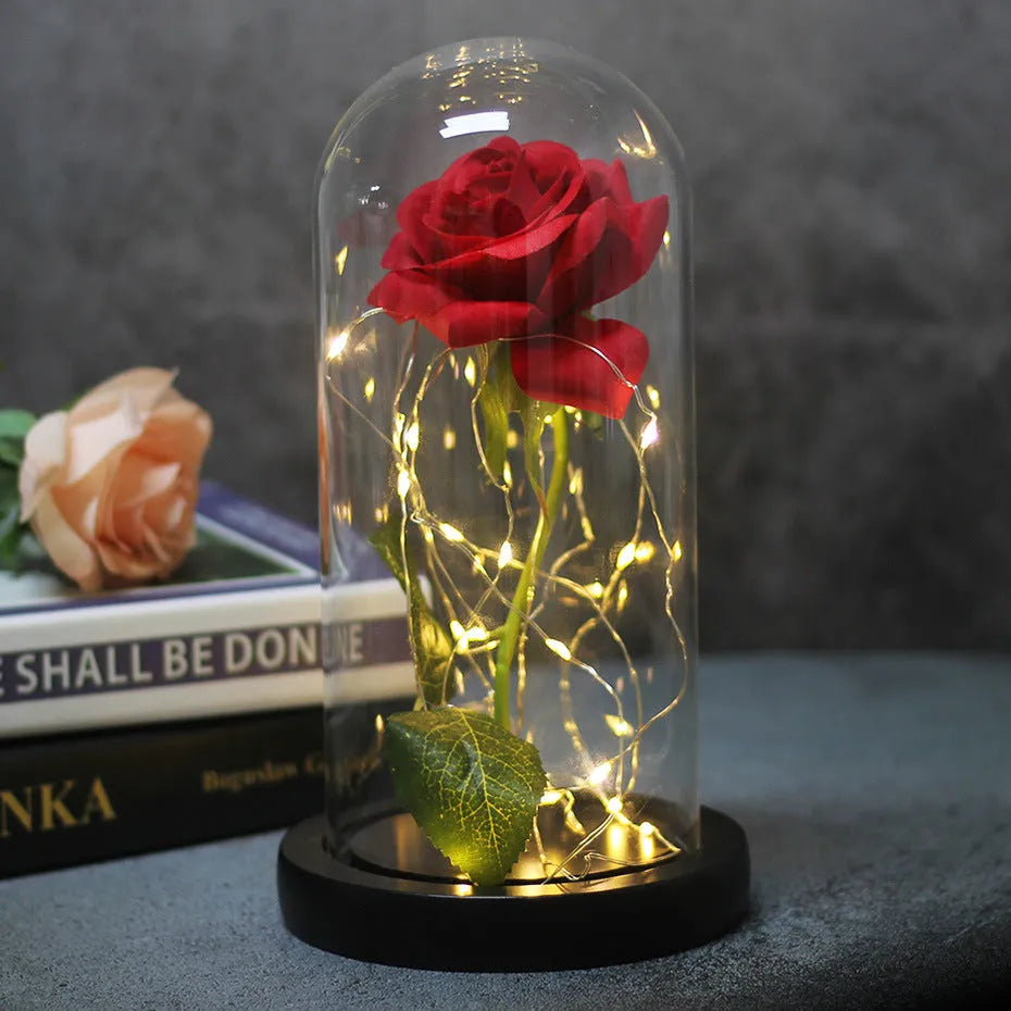 LED illuminated silk rose bouquet with glass cover in a gift box, showing warm white lights.