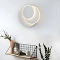 Modern round acrylic LED wall lamp with push button switch in black or white.