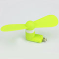 Portable white mini fan with plastic blades connected to a smartphone showing rotary switch.
