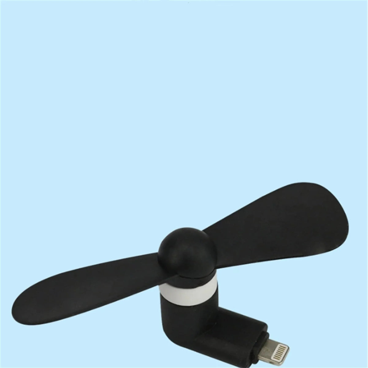 Portable white mini fan with plastic blades connected to a smartphone showing rotary switch.