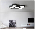Geometric shaped iron frame LED wall light with remote control in black or white