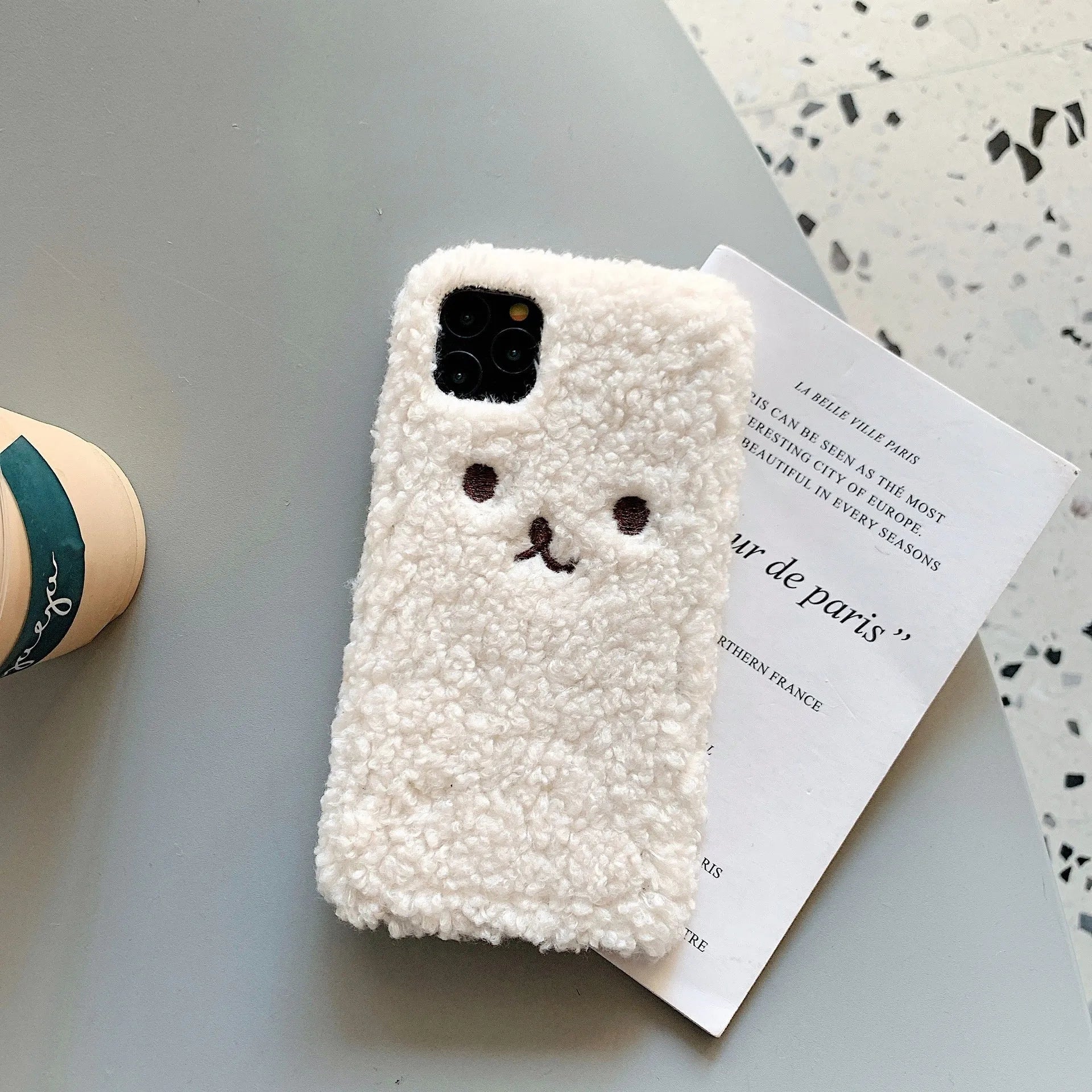 Brown and white embroidery plush cartoon bear design on a soft TPU iPhone phone case.