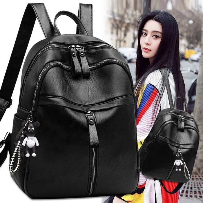 Black soft surface PU leather travel backpack with double straps and luggage strap attachment