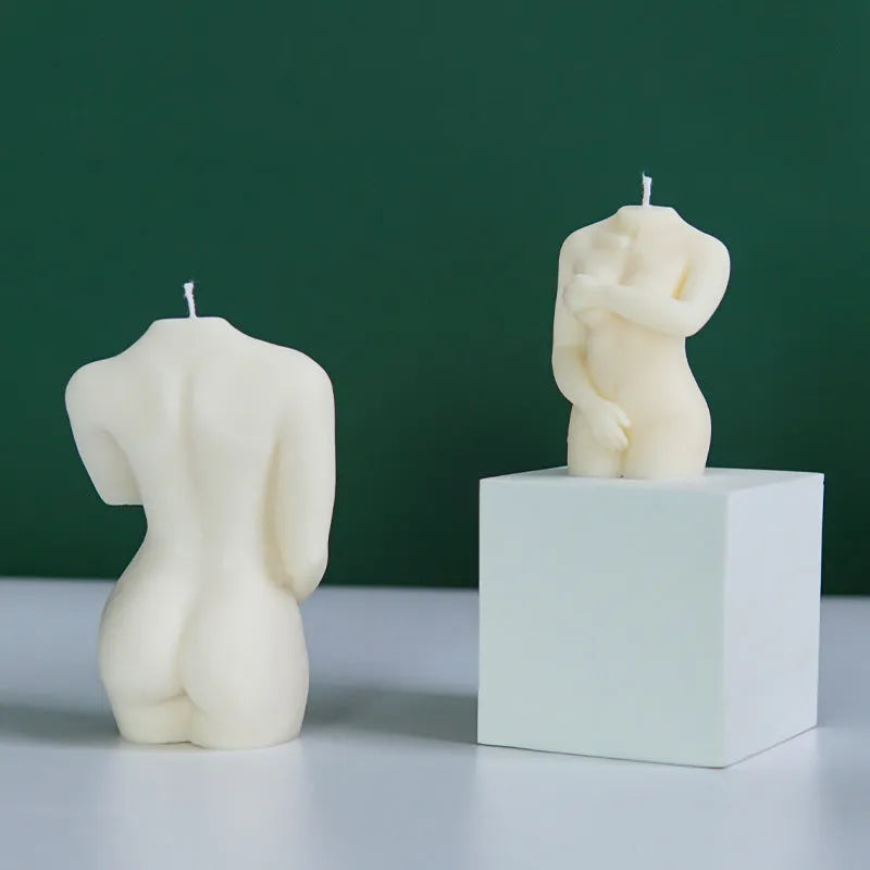 Flexible silicone candle mould in a detailed shy female body shape on a white background.