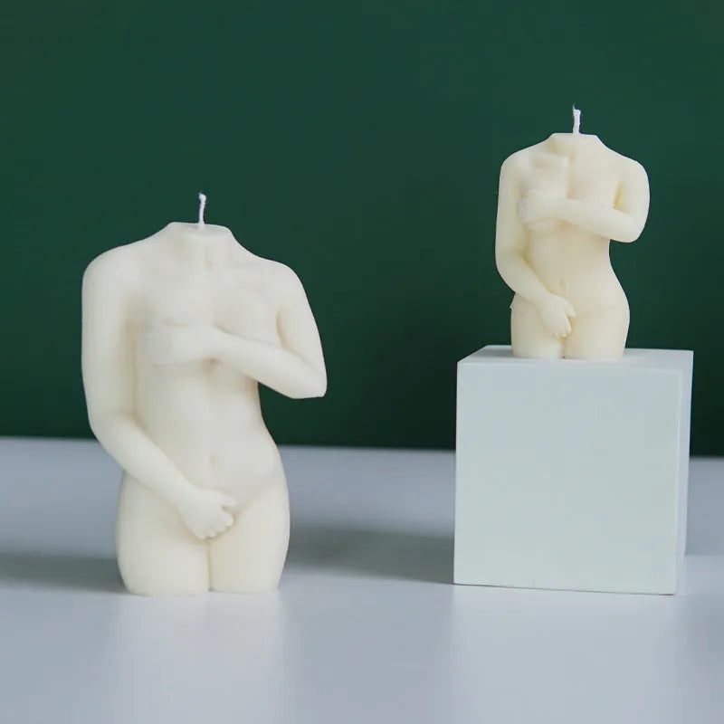 Flexible silicone candle mould in a detailed shy female body shape on a white background.