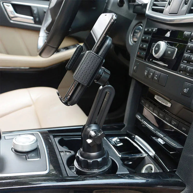 Black ABS car mobile phone holder with adjustable height and 360-degree rotating bracket on a car dashboard.