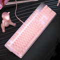 Pink wired mechanical keyboard and matching mouse with green switches on a desk.