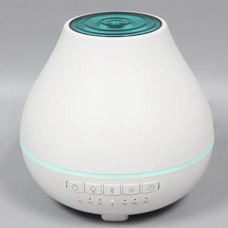 White round Bluetooth humidifier and aroma diffuser with night light on wooden surface