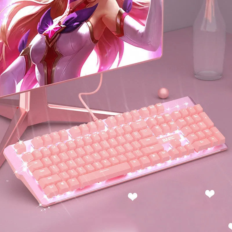 Pink wired mechanical keyboard and matching mouse with green switches on a desk.