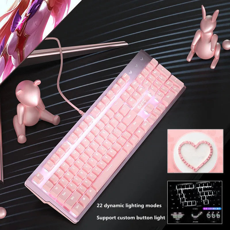 Pink wired mechanical keyboard and matching mouse with green switches on a desk.