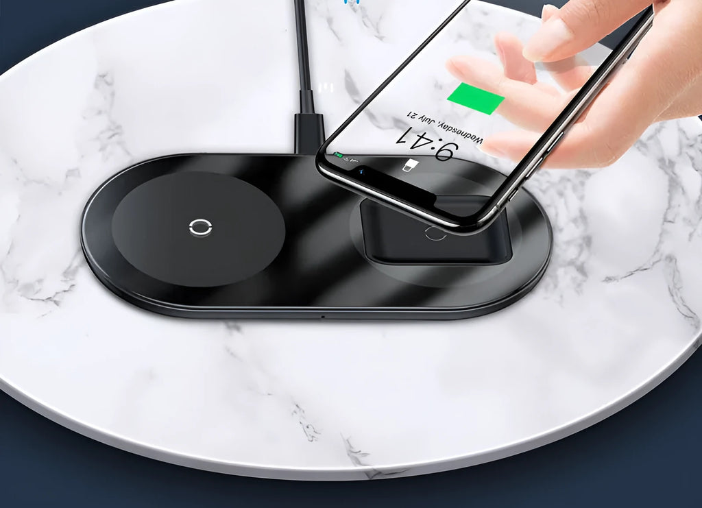 Baseus black wireless charger charging iPhone and AirPods simultaneously on wooden desk