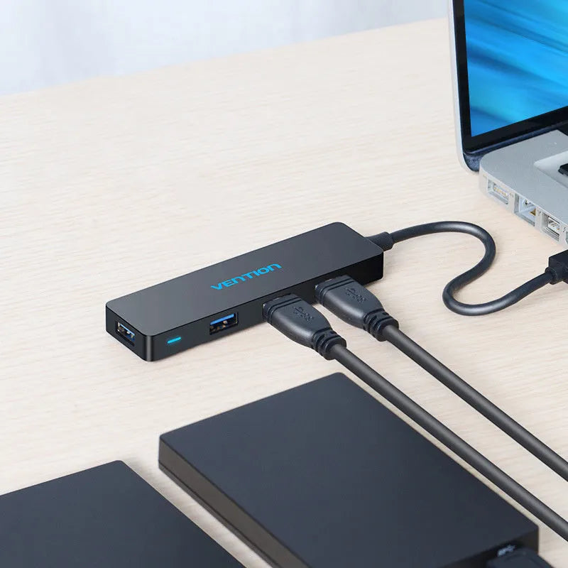 Black USB 3.0 hub with four ports and a short 0.15 metre cable