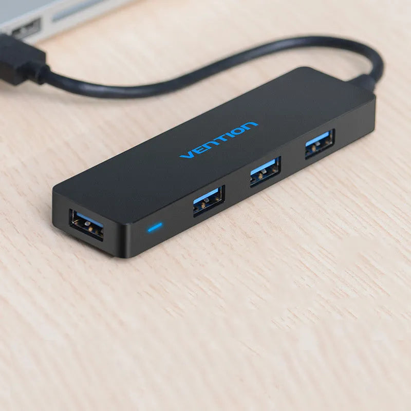 Black USB 3.0 hub with four ports and a short 0.15 metre cable