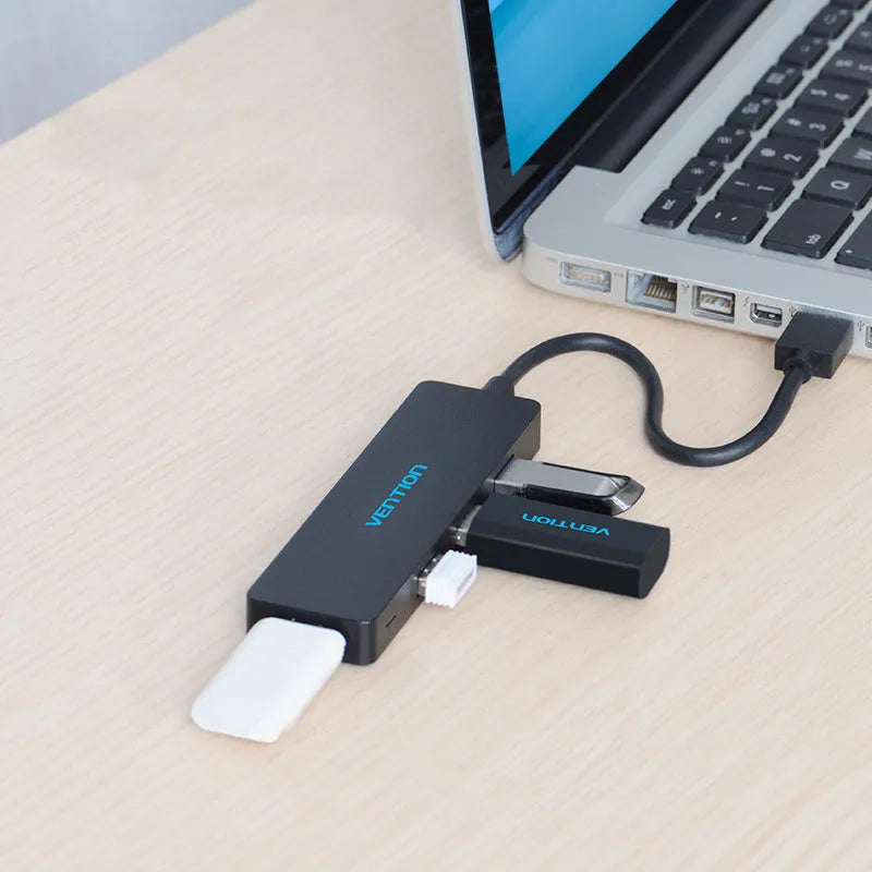 Black USB 3.0 hub with four ports and a short 0.15 metre cable