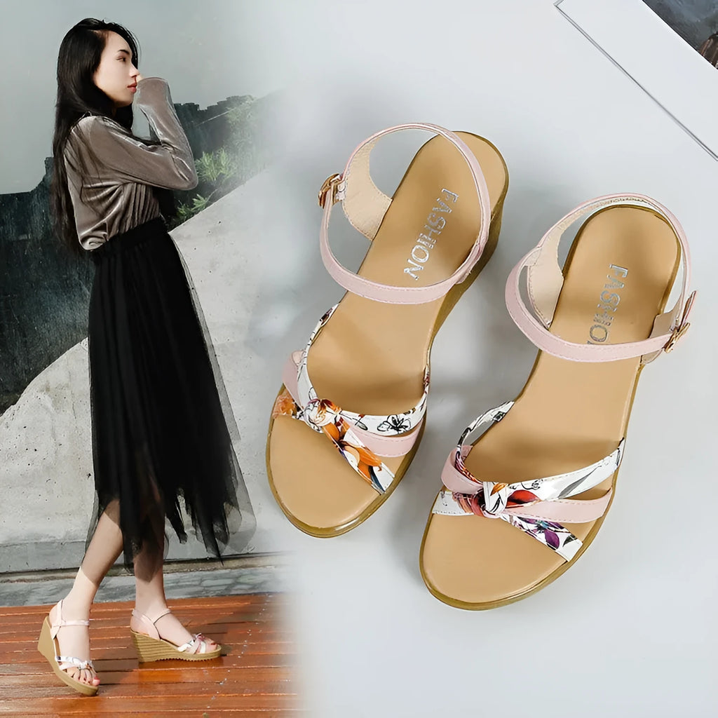 Pink and white women's wedge sandals with a thick heel and buckle strap.