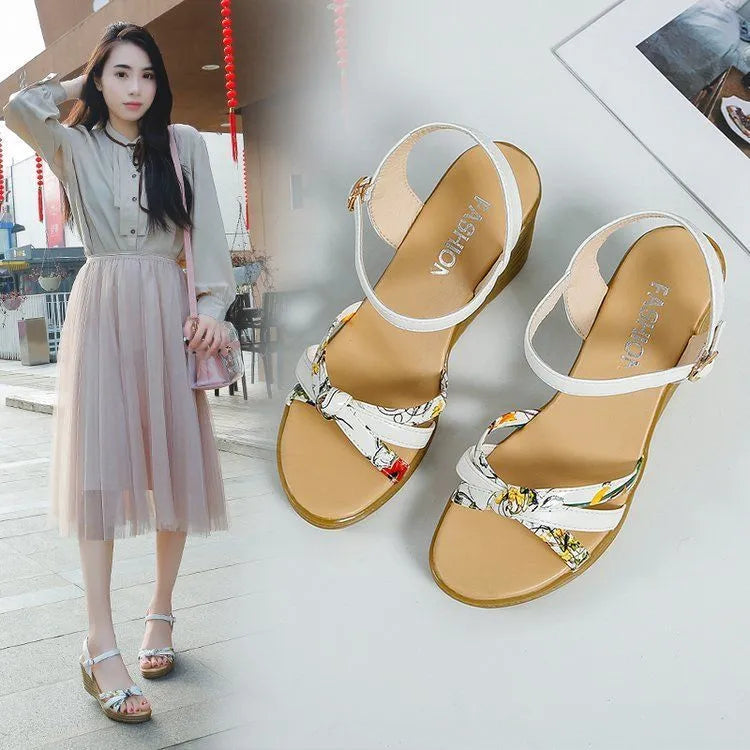 Pink and white women's wedge sandals with a thick heel and buckle strap.