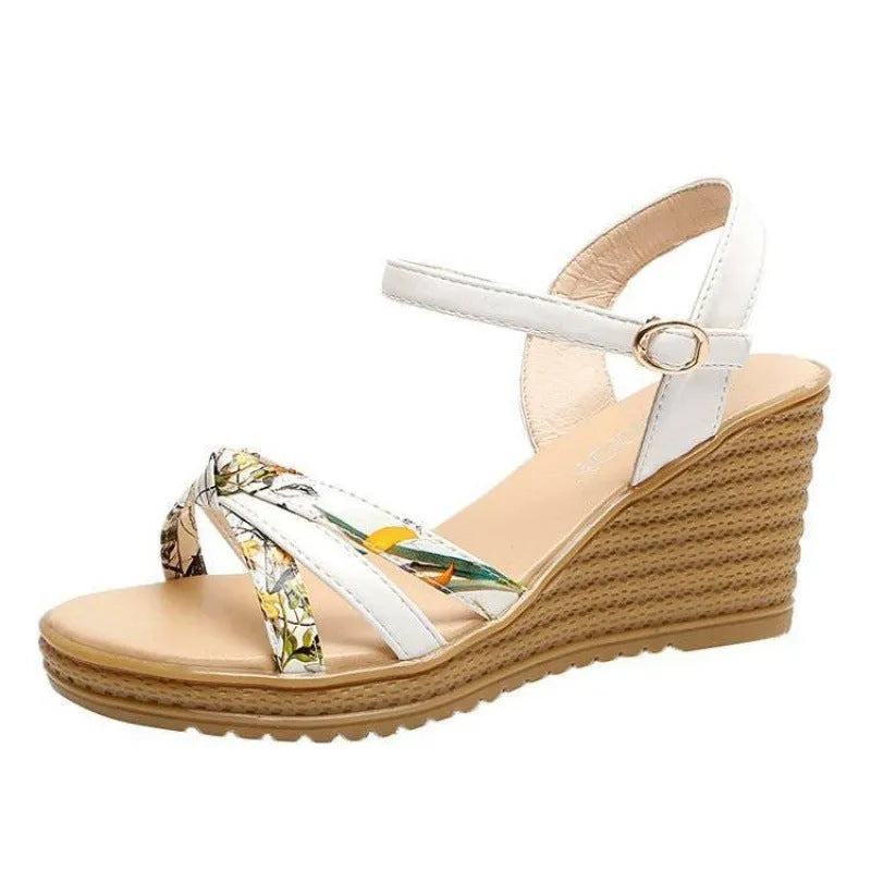 Pink and white women's wedge sandals with a thick heel and buckle strap.