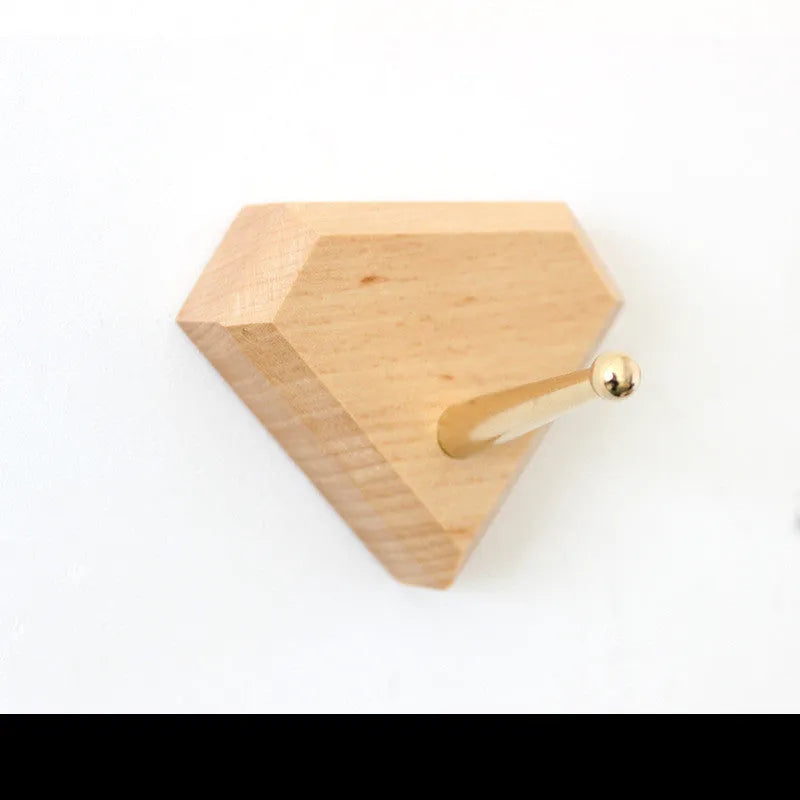 A natural beech wood adhesive wall hook in a simple single hook design, shown alongside other shape variants.
