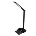Black wireless charging desk lamp with touch switch and USB cable on a wooden desk.