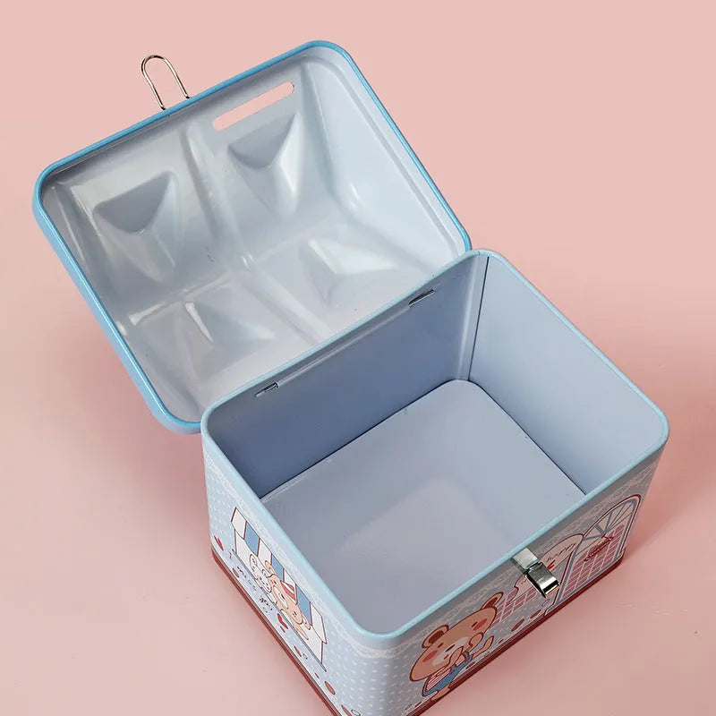 Blue house-shaped tinplate piggy bank for coin storage on desktop