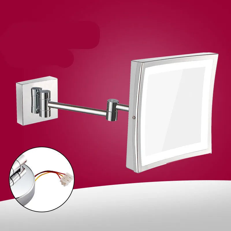 Stainless steel folding makeup mirror with a large silver mirror lens on a flat surface.