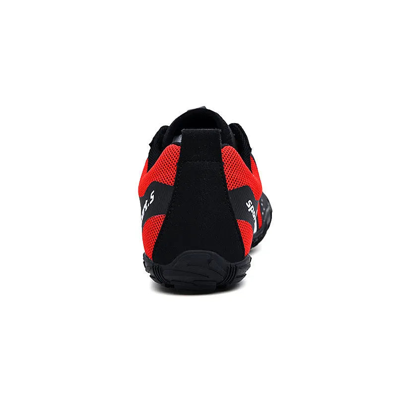 Quick-drying outdoor wading shoes in red, with mesh upper and rubber sole, on a rocky shore.