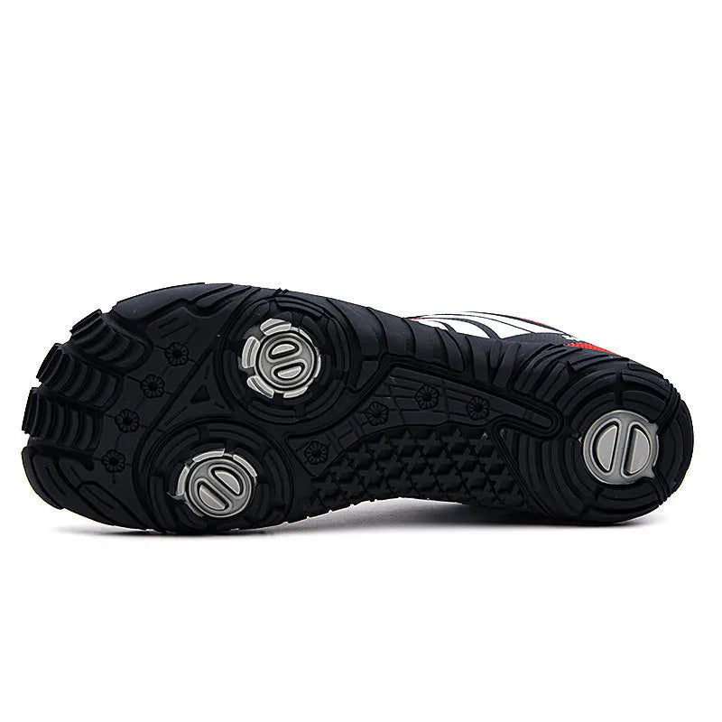 Quick-drying outdoor wading shoes in red, with mesh upper and rubber sole, on a rocky shore.
