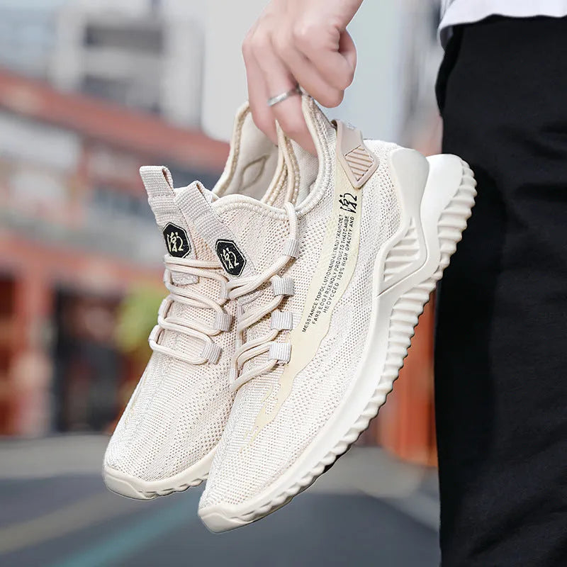 Men's white mesh sports trainers with rubber soles and lace-up closure on wooden floor