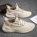 Men's white mesh sports trainers with rubber soles and lace-up closure on wooden floor