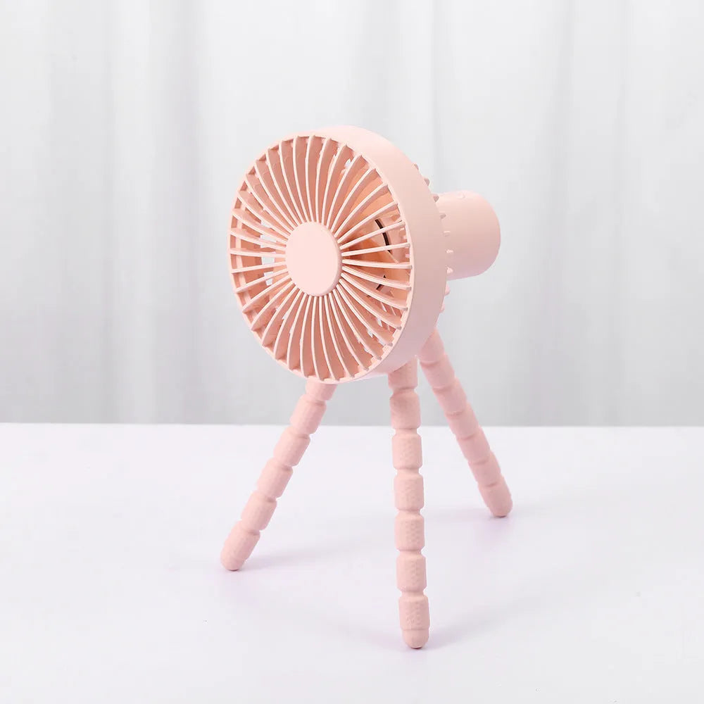 Compact portable desktop fan with flexible tripod stand and bending head, shown in white colour on a desk.