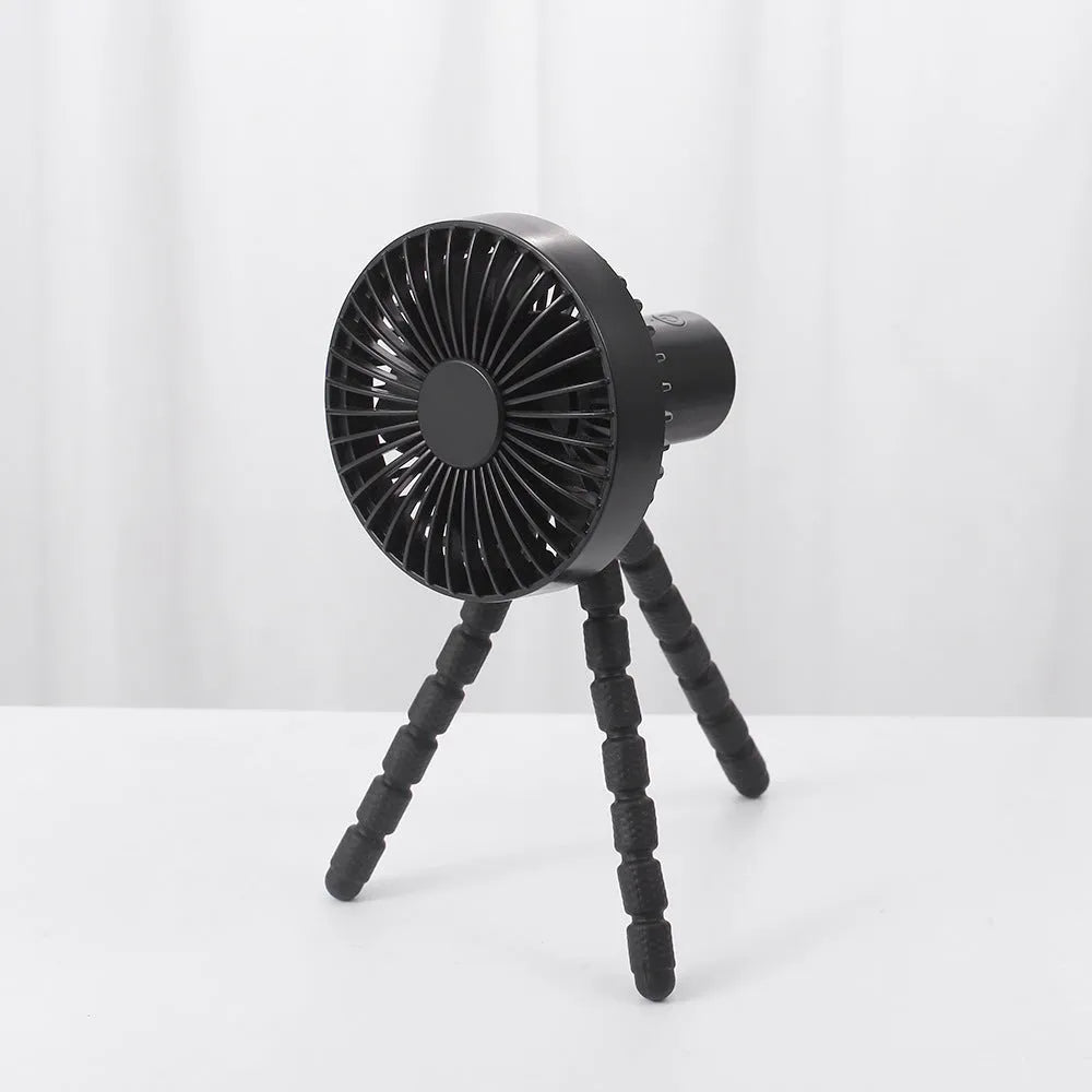Compact portable desktop fan with flexible tripod stand and bending head, shown in white colour on a desk.
