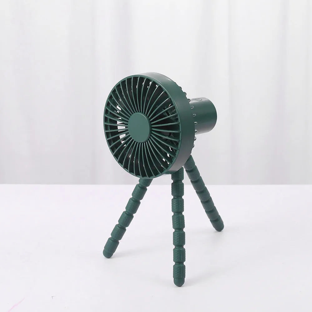 Compact portable desktop fan with flexible tripod stand and bending head, shown in white colour on a desk.