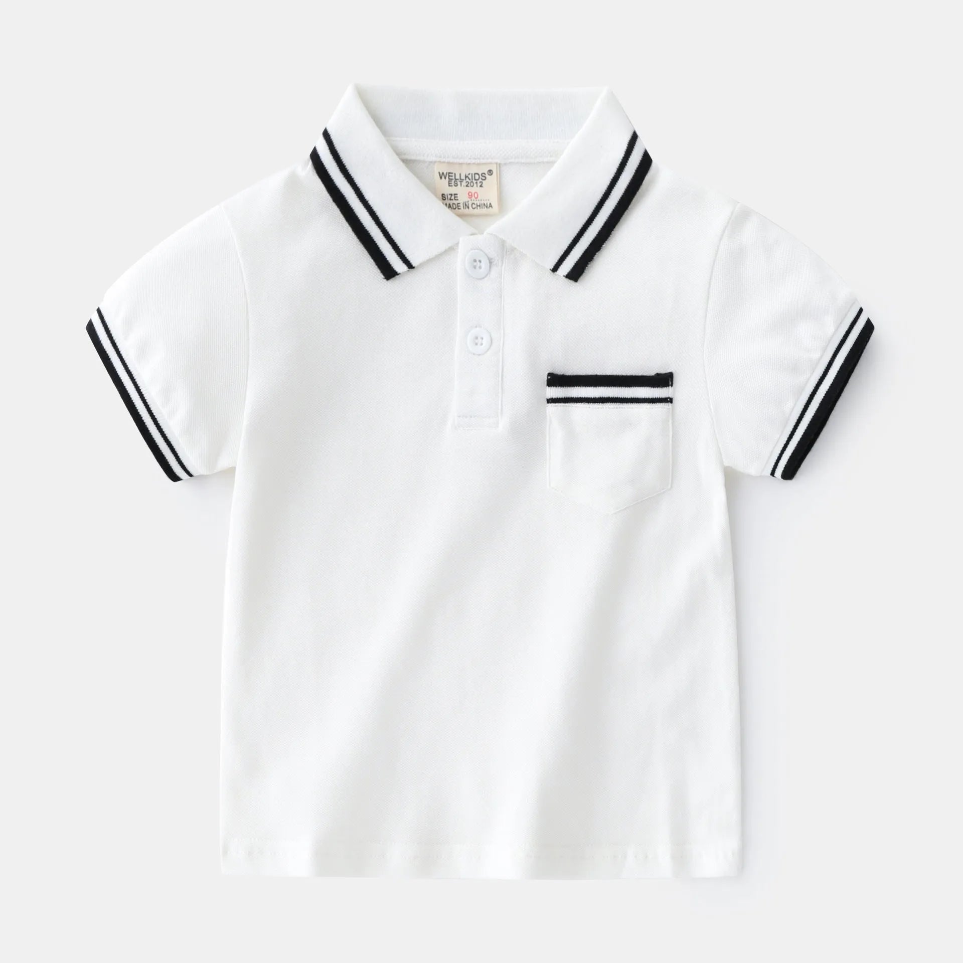White and black boys' short sleeve cotton polo shirt laid flat.