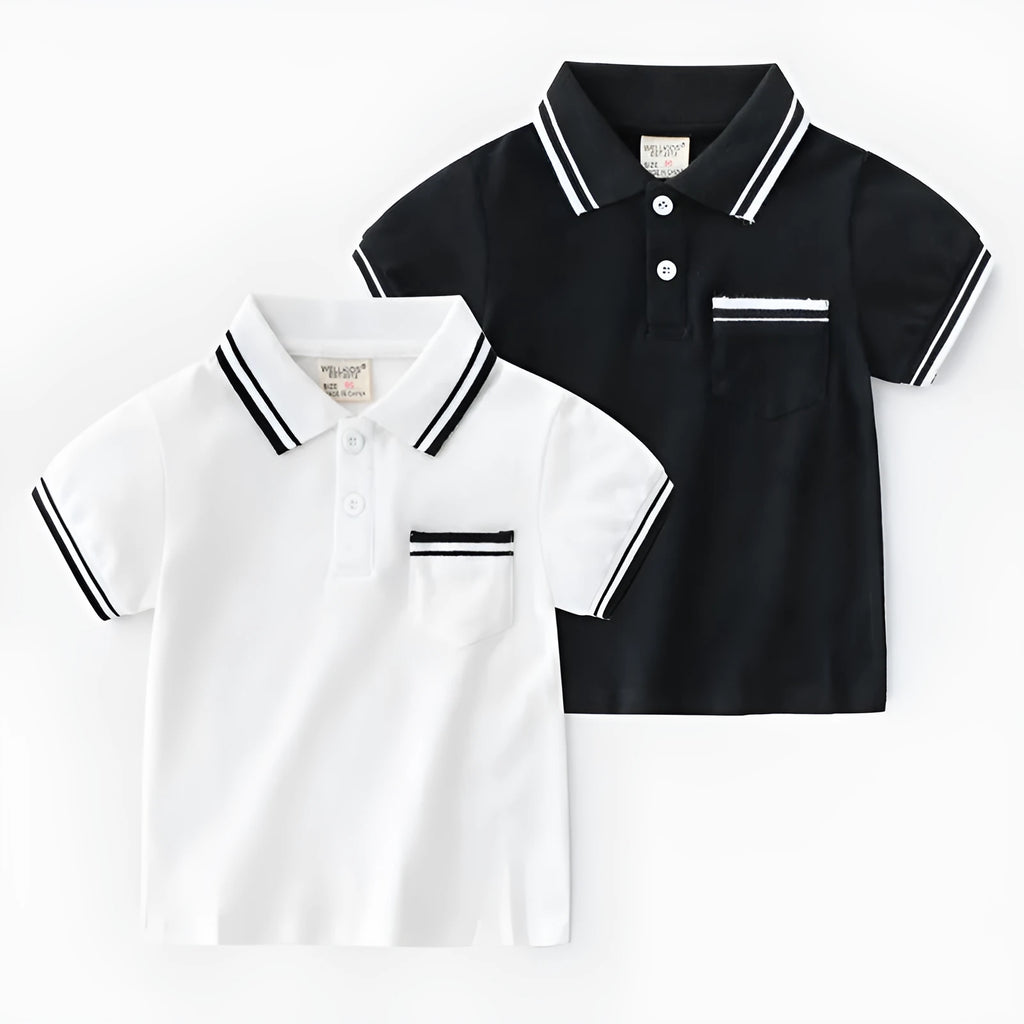 White and black boys' short sleeve cotton polo shirt laid flat.