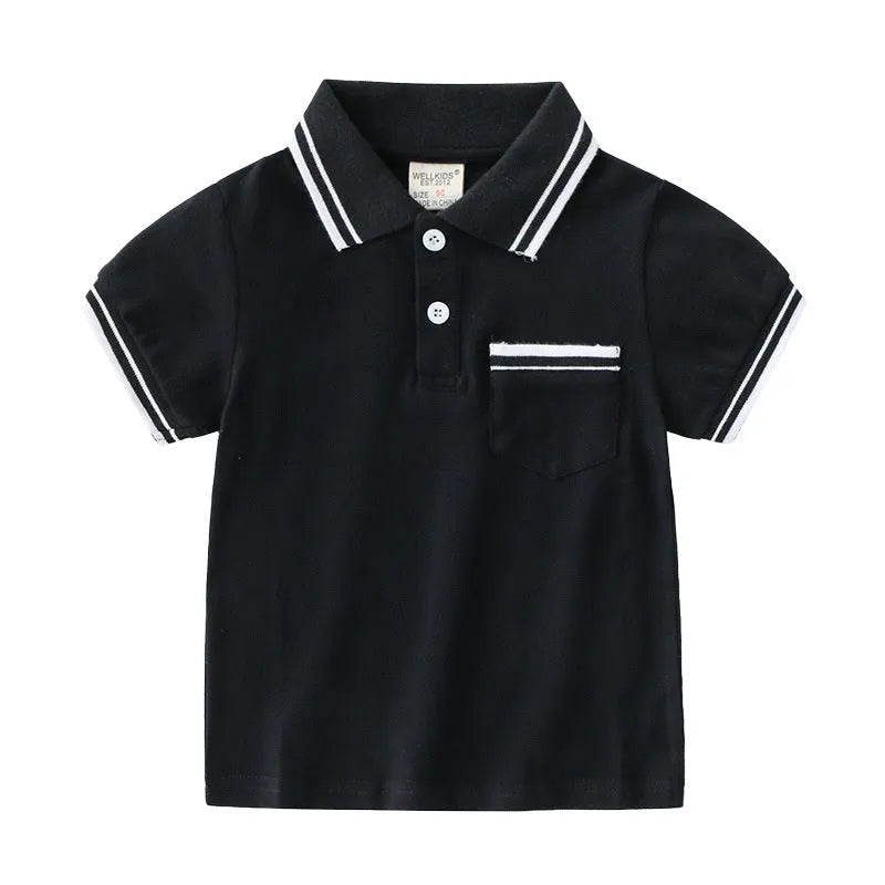 White and black boys' short sleeve cotton polo shirt laid flat.