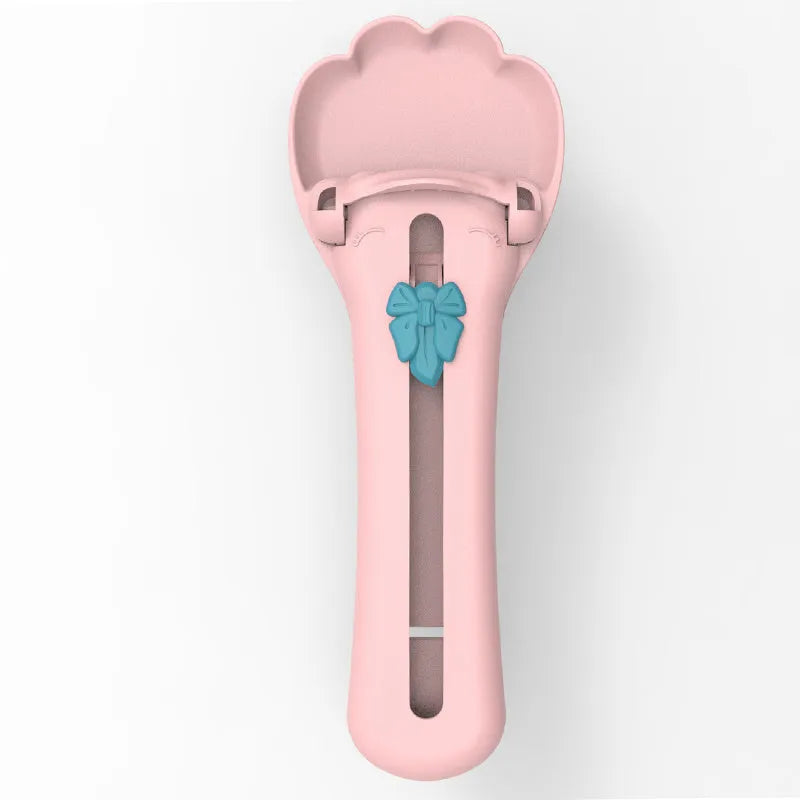 Multipurpose pet food dispenser tool in green and pink colours for squeezing liquid food and extruding treat bars