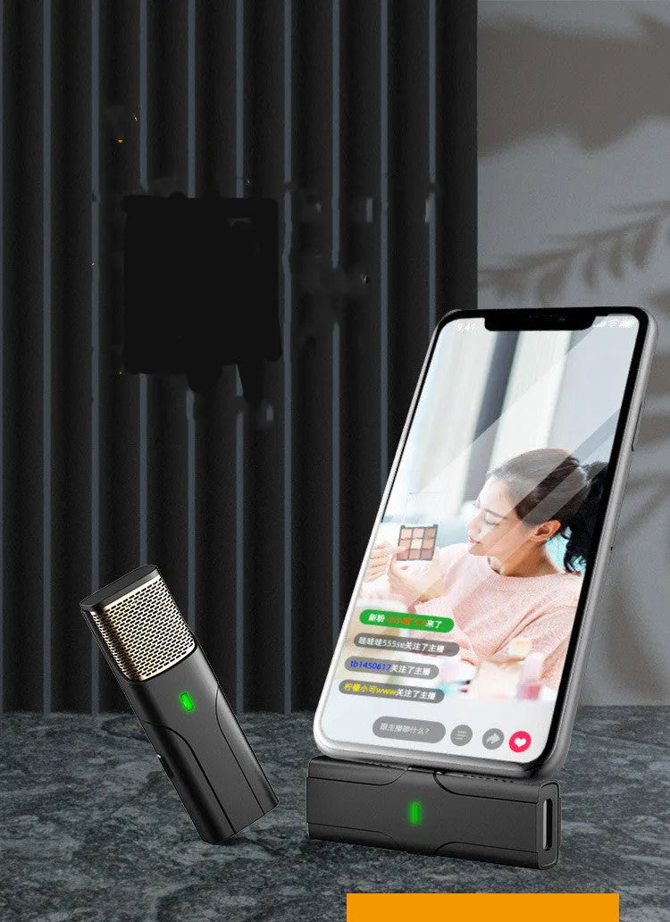 Black wireless lavalier microphone with charging cable for mobile phone recording.