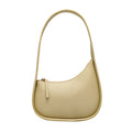 Small half-moon shaped leather ladies handbag with wide shoulder strap and zip opening