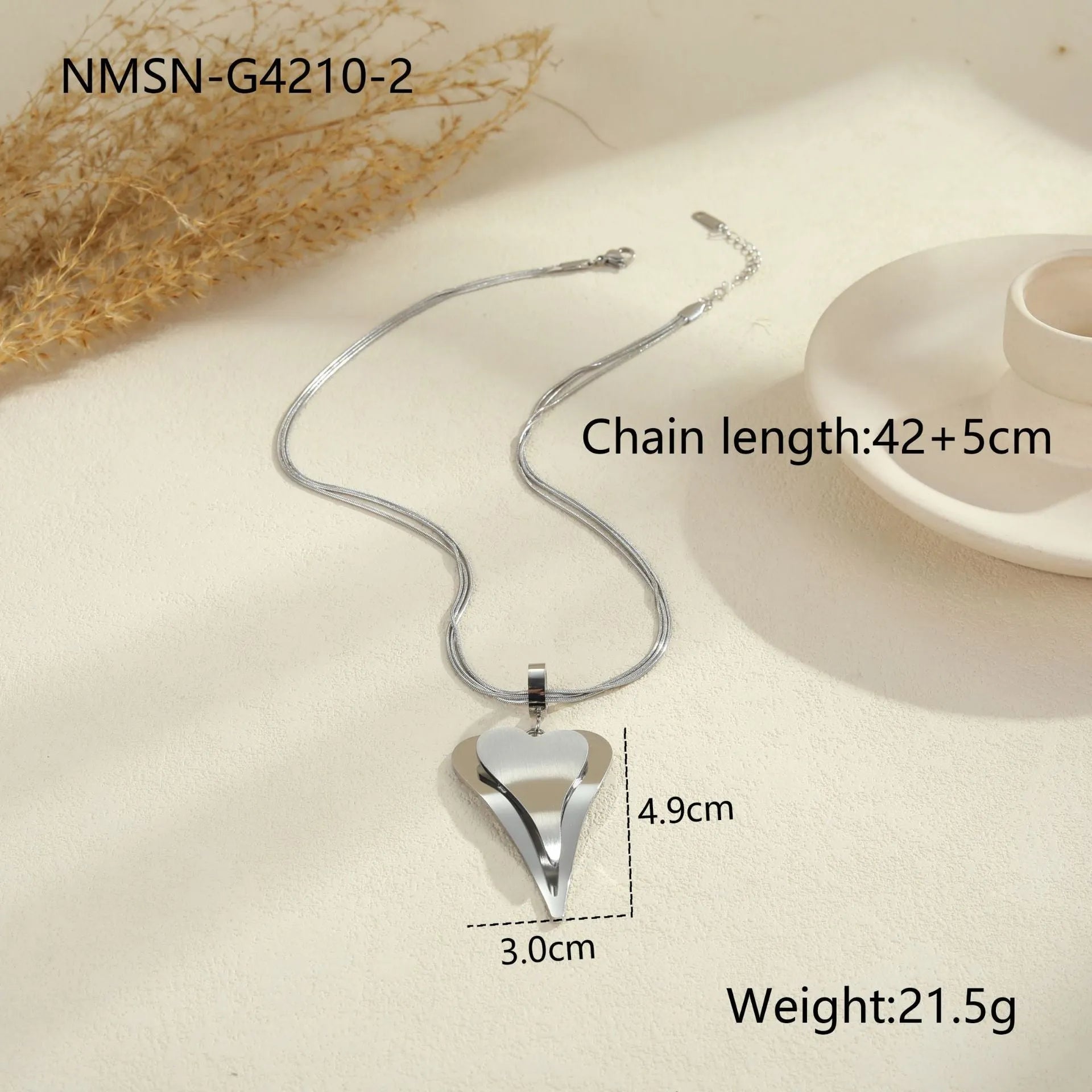 Geometric double-heart pendant on a stainless steel snake bones chain necklace for women, shown in gold and steel finishes.