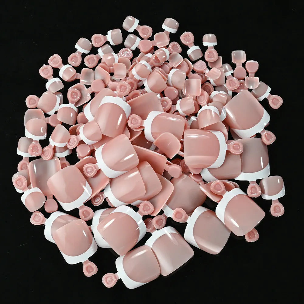 120 piece box of square short French style artificial toe nails with white tips on nude base.