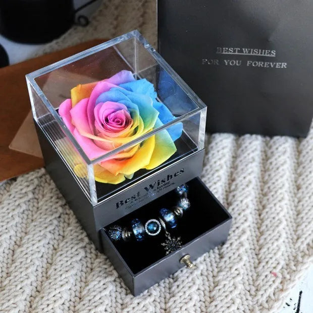 Glass eternal flower jewellery box with preserved roses and carnations inside measuring 8.5cm square