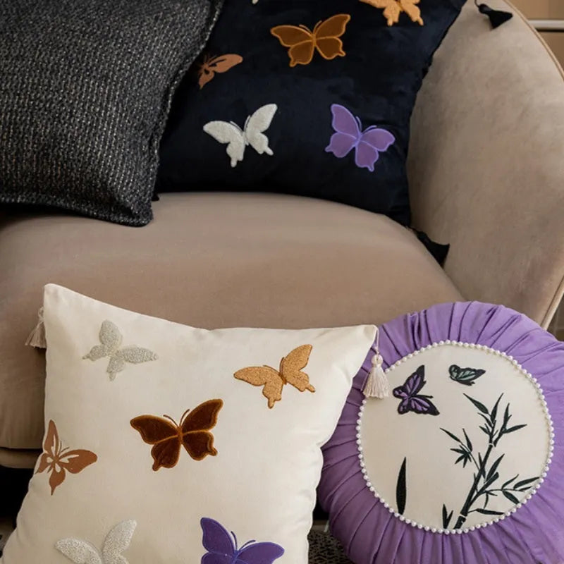 Square embroidered cushion with butterfly floral pattern in Chinese style, shown in beige colour.