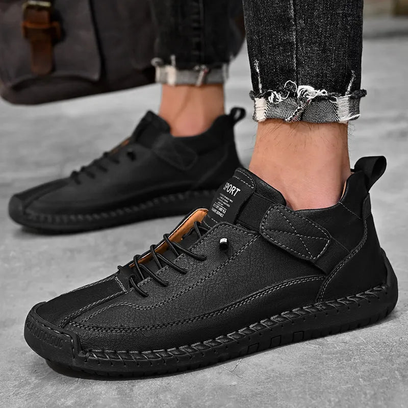 Men's mid-calf black Martin boot with stitching detail and elastic side band, flat rubber sole.