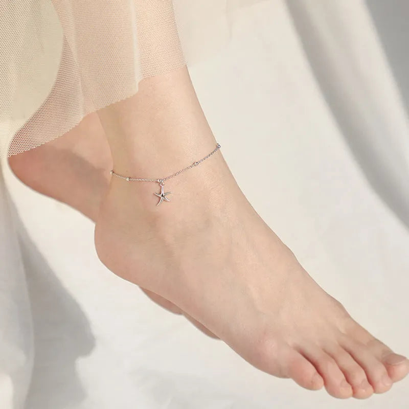 Sterling silver anklet with starfish charm and round beads on ankle