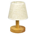 Korean style table lamp with white linen shade and bamboo holder on wooden table