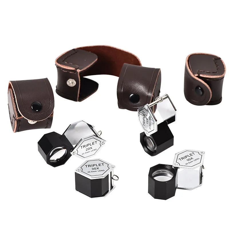 Handheld metal jeweller's loupe with optical glass lens for stamp and coin identification.