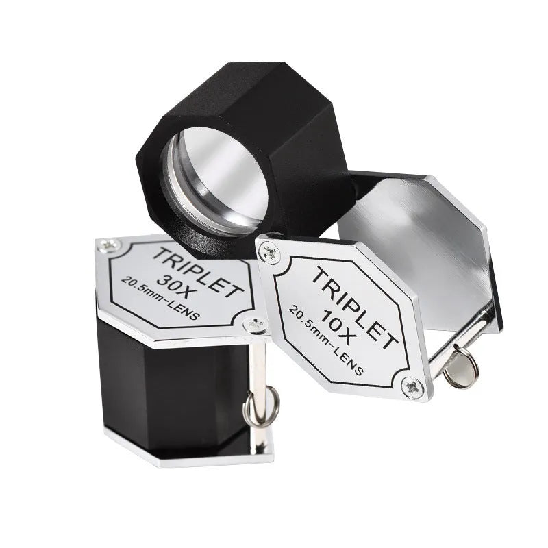 Handheld metal jeweller's loupe with optical glass lens for stamp and coin identification.