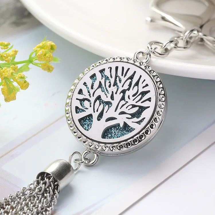 Alloy tassel car pendant with long chain hanging, showing decorative box detail.